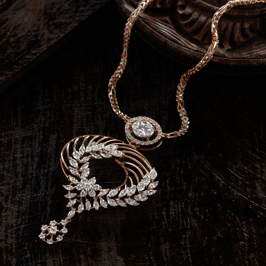 Rose Gold and Diamonds Pendant with a rose gold chain on dark brown wooden background