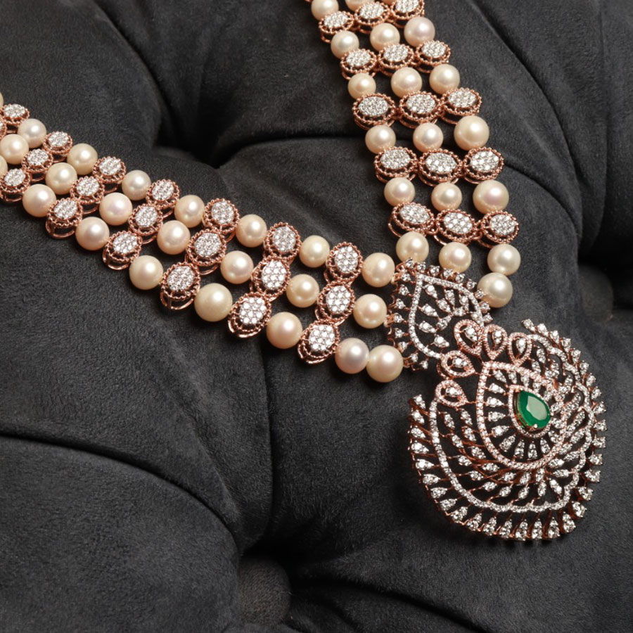 Diamond, Pearls and Emerald Ornamental Necklace on a black cushion background