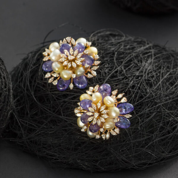 Purple and White Pearls and Diamond Floral Earrings on a dark background