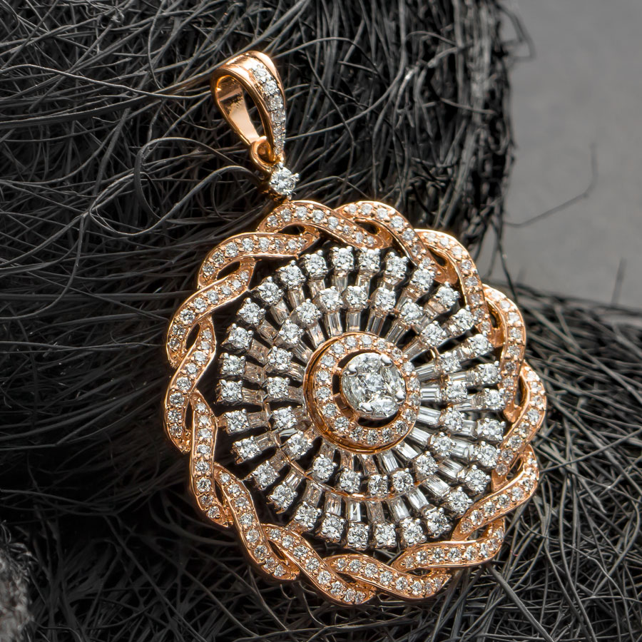 Rose Gold Coiled Diamond Pendant placed on a ball of black thread