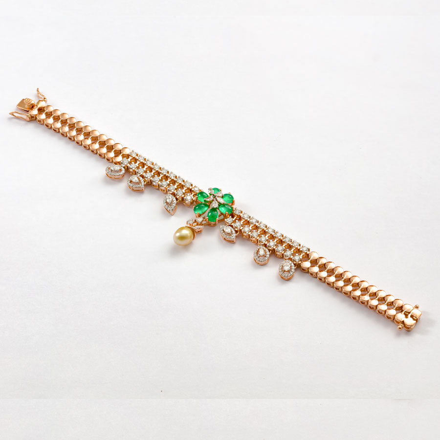 Diamond and Emerald Floral Bracelet on a white background
