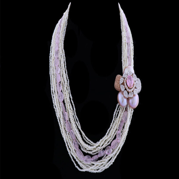 Pear strings and diamond and pearls floral motif necklace on black background