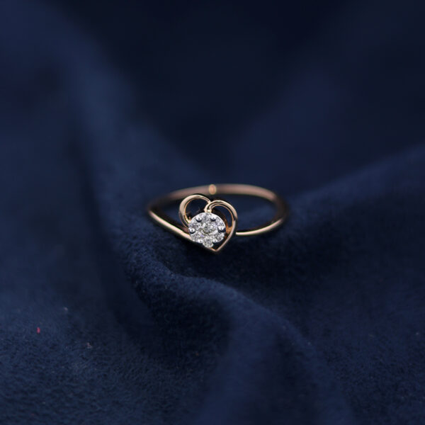 real diamond heart ring on dark blue suede fabric