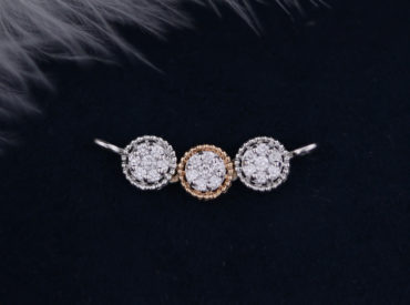 Triple diamond pendant on a dark blue background and white fur on top left